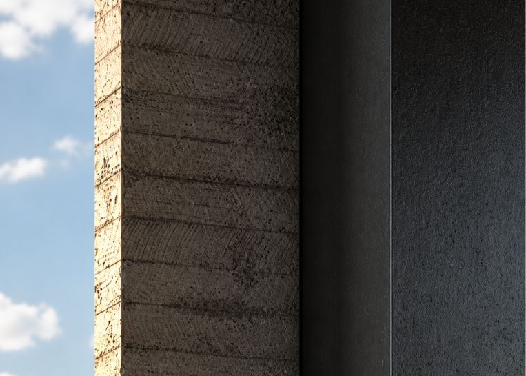Nahaufnahme der hochwertigen Oberflächenstruktur: Ein robuster Beton-Pfeiler kontrastiert mit der glatten, dunklen Stahlverkleidung des Stylefire I.
