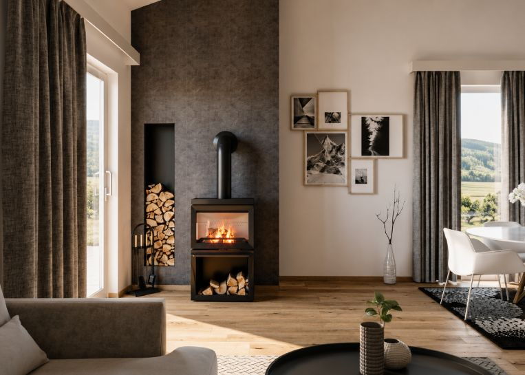Gesamtansicht des Jotul F520 vor einer grau gespachtelten Wand mit integrierter Holznische und moderner Bildergalerie.