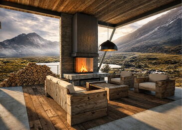 Ein moderner Stylefire III Kamin mit U-Sichtscheibe in einer luxuriösen, überdachten Outdoor-Lounge mit Blick auf eine Berglandschaft.