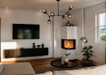 Ein moderner Spartherm Eckkamin mit weißem Ofenkörper und 2-seitiger Sichtscheibe in einem zeitgemäßen Wohnraumambiente.